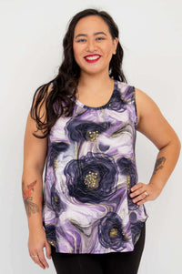 Woman wearing sleeveless bamboo tank in purple lotus flow floral print, front view