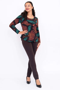 Model posing sideways in Jazz bamboo leaf print top and brown pants