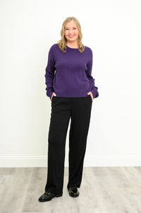Front view of a vibrant amethyst knit top and black trousers, highlighting a comfortable, relaxed silhouette.