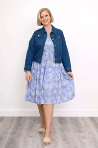 Woman styling the Juni Dress with a denim jacket and beige sandals