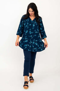 Model playfully spreading out the Kary Tunic Top with both hands