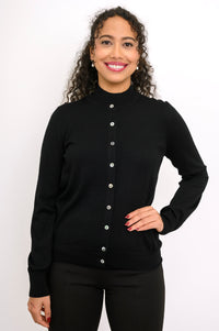 Studio portrait of a model in a black long sleeve button down wool cardigan sweater with ribbed trim.