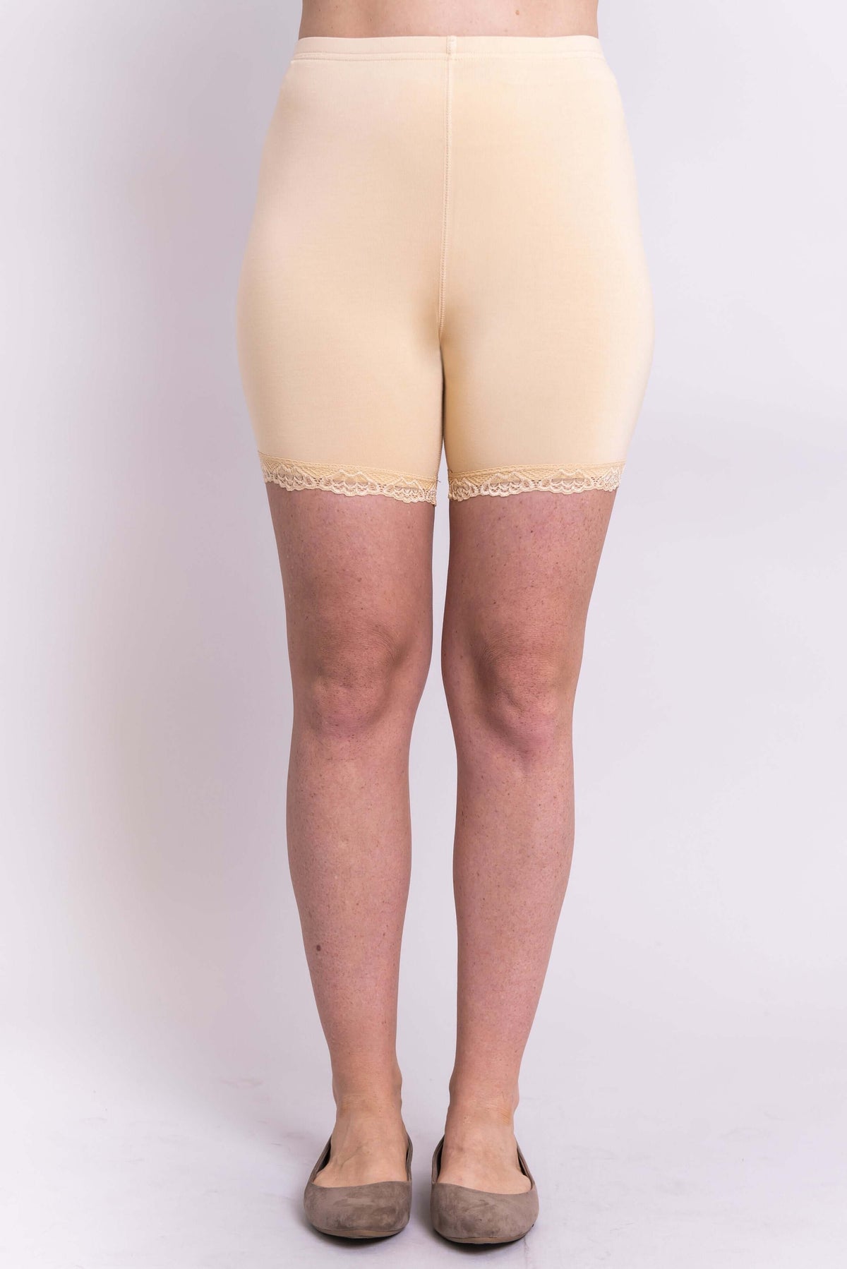 Model wearing bamboo nude undershorts with lace trim, front view