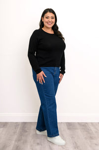 Side-facing view of an onyx raglan sweater, showcasing extended cozy coverage sleeves and a mid-hip length profile.