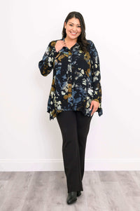 Woman smiles wearing Laney Blouse Night Bloom, hand near collar