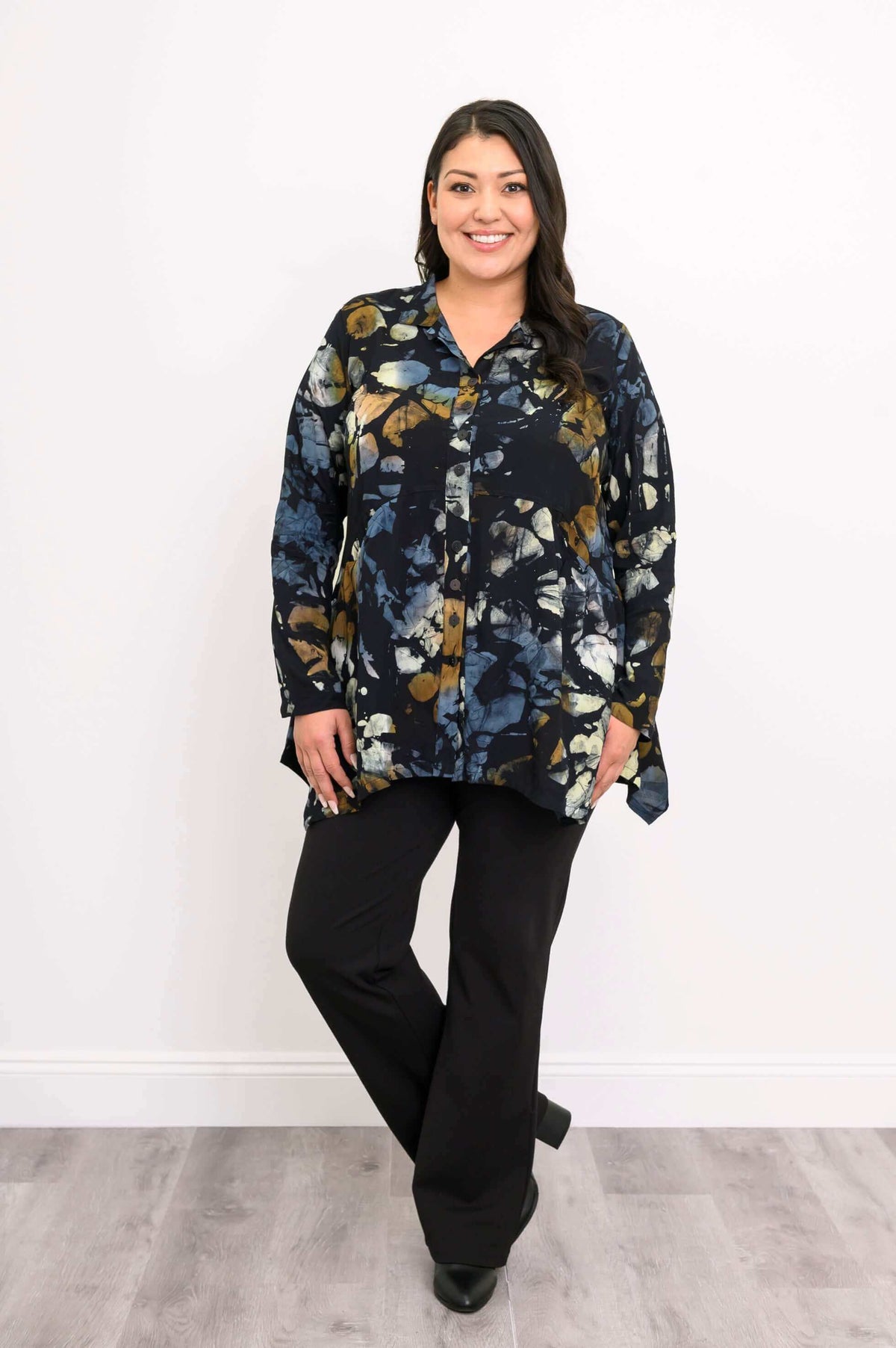 Front view of woman standing in Laney Blouse Night Bloom, arm relaxed