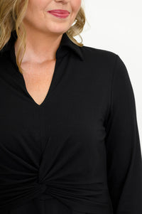 Close up view of woman wearing long black dress on a white background