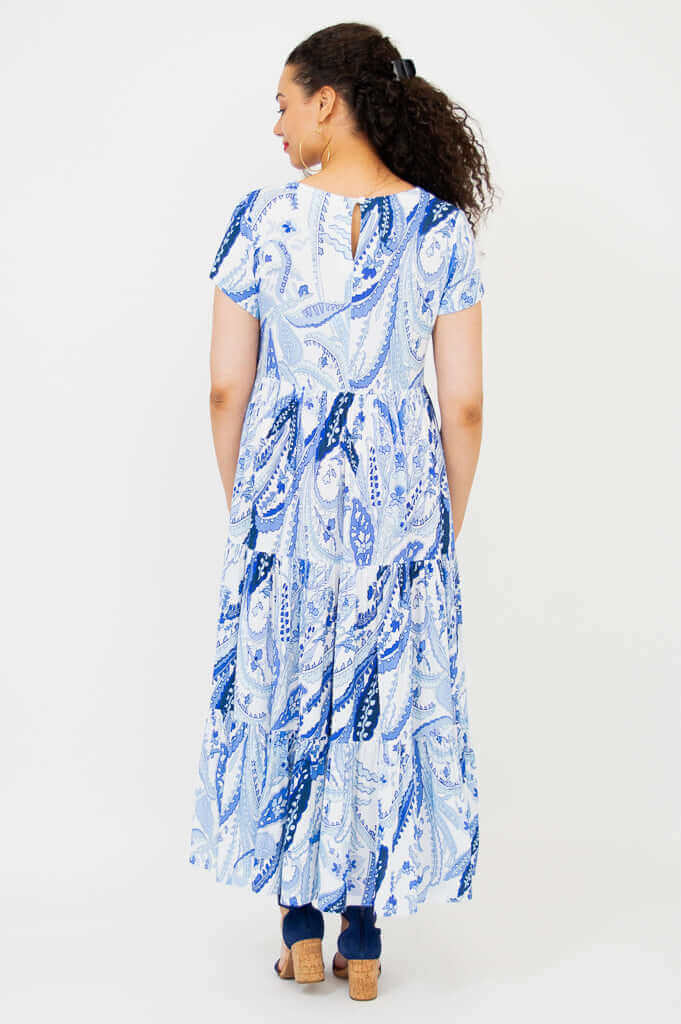 Back view of model wearing Laurita Maxi Dress in blue and white paisley print
