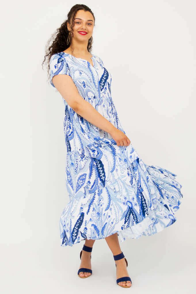 Model twirling in the Laurita Maxi Dress with blue and white paisley pattern