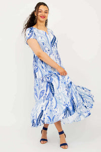 Model twirling in the Laurita Maxi Dress with blue and white paisley pattern