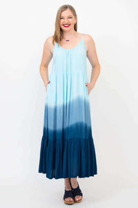 Woman wearing a light blue to dark blue ombre maxi dress with adjustable straps, front view