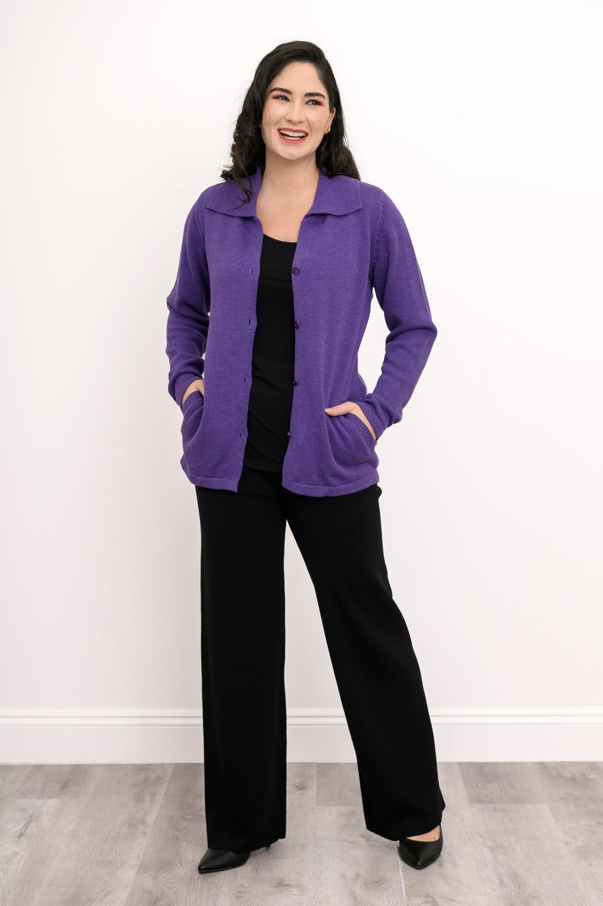 Front view of a violet long-sleeve sweater jacket with a traditional collar, showing a casual weekend outfit.