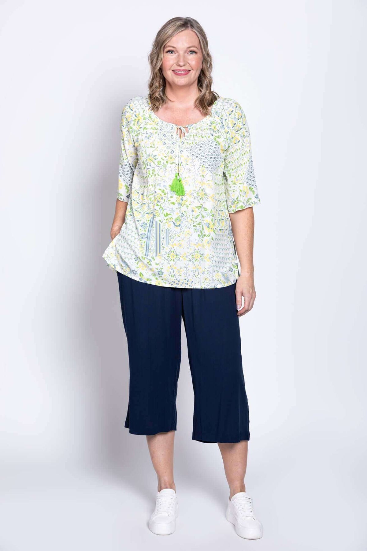 Woman posing in a Luna Boho Peasant Top, showing loose fit and casual styling