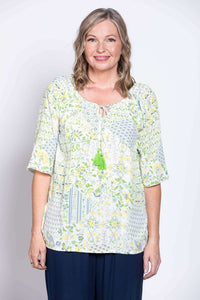 Woman wearing a Luna Boho Peasant Top with a floral print and tie-front detail, front view