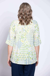 Back view of woman modeling Luna Top featuring floral boho print and relaxed fit