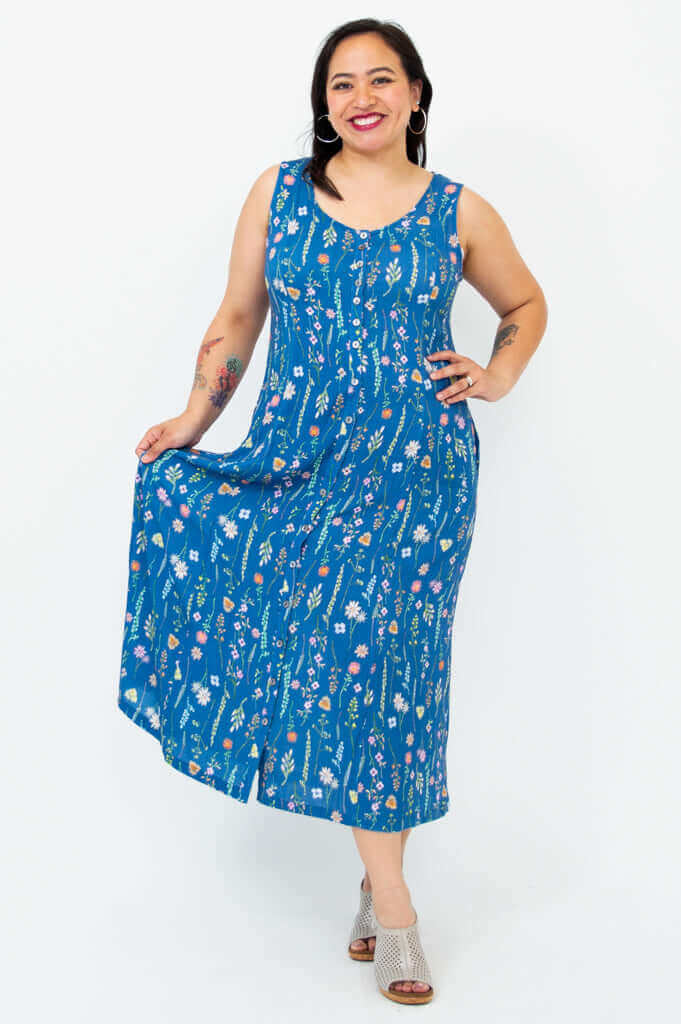 Model holding skirt of the Madison maxi dress in blue wildflower print