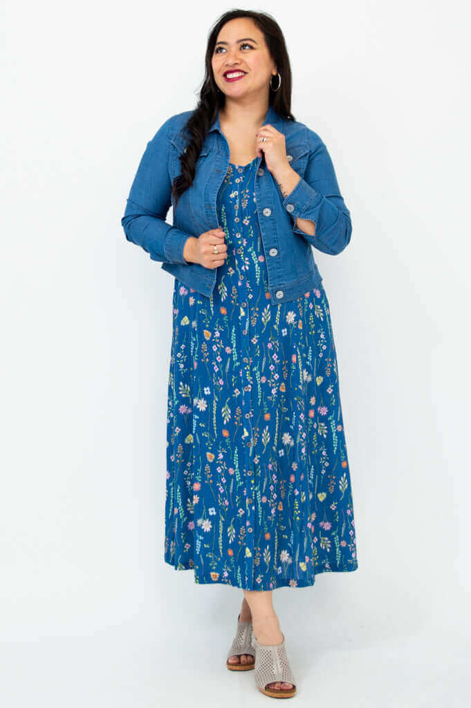 Model smiling in Madison maxi dress with denim jacket, blue wildflower print