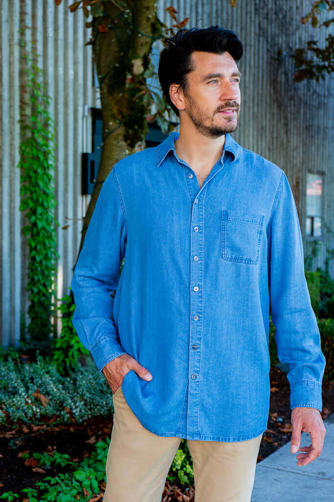 Man standing outdoors in light blue button-up shirt with collar and front pocket