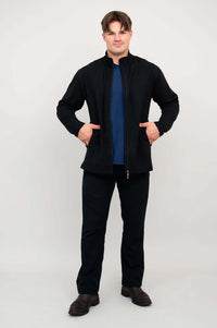 Man showing open black fleece jacket over blue shirt