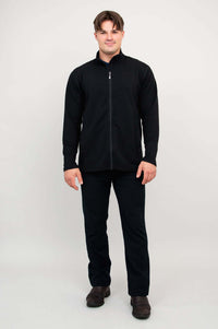 Man standing straight in black fleece jacket, hands by sides