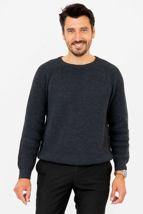 Man wearing a charcoal ribbed crewneck sweater, facing forward