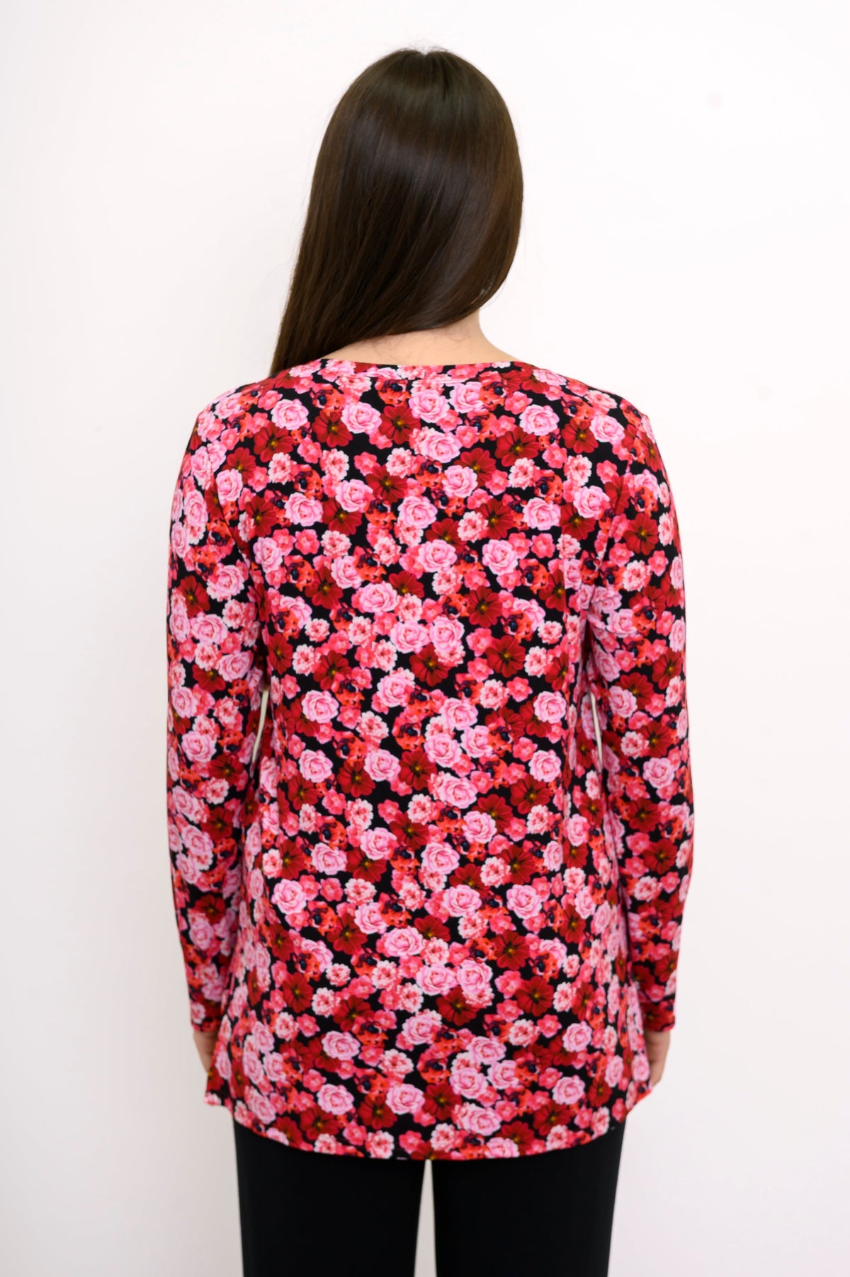 Back view of a pink and red floral print bamboo top, showcasing a relaxed-fit drape and straight-cut hemline.