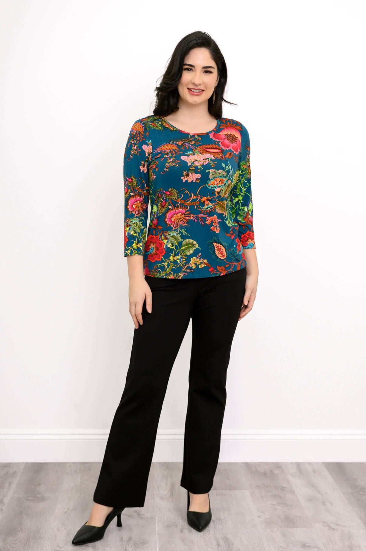 Woman in blue bamboo floral tee, smiling, front full-length view