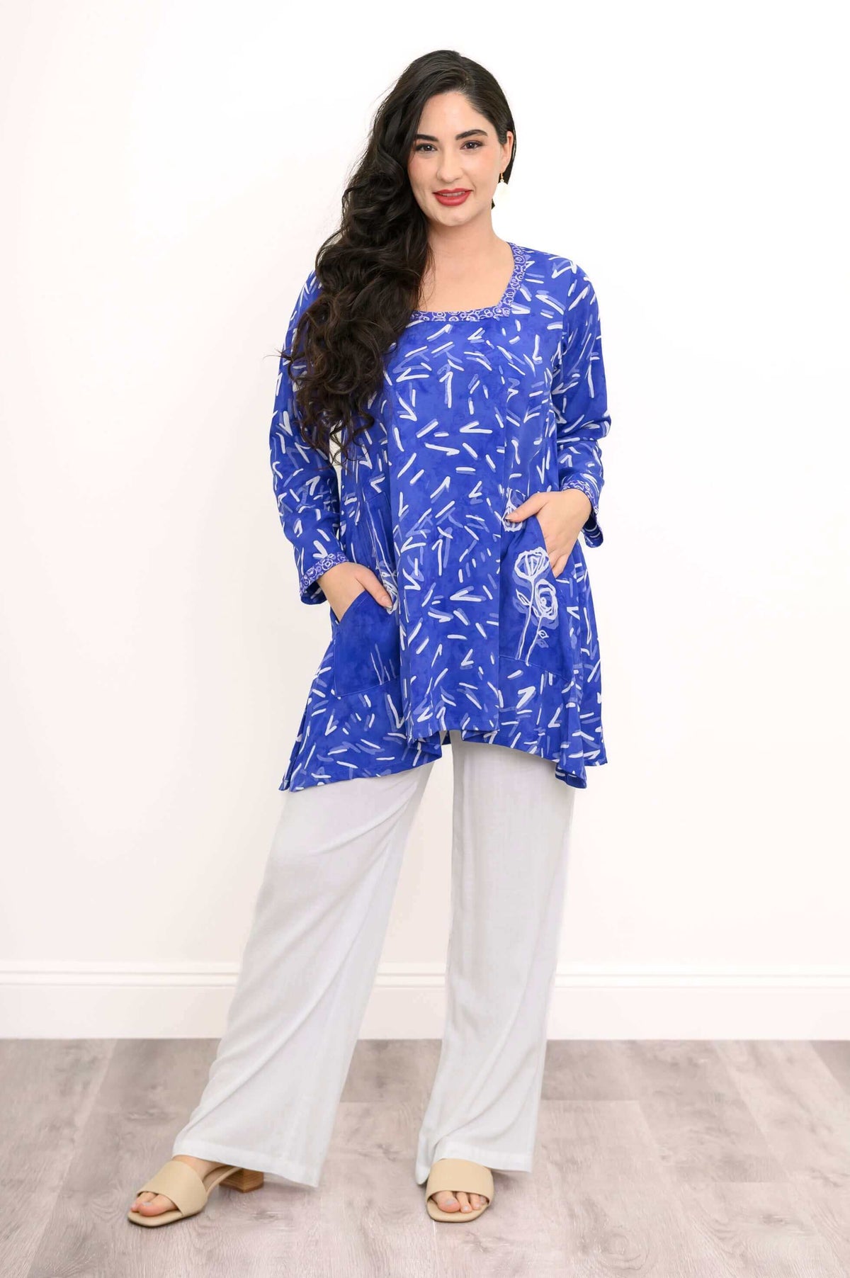 Woman posing in blue patterned Maria tunic with patch pockets and relaxed fit
