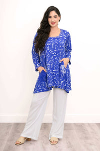 Woman posing in blue patterned Maria tunic with patch pockets and relaxed fit