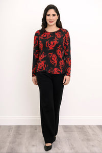 Model posing in a black and red floral print bamboo shirt paired with wide-leg black trousers, front view.