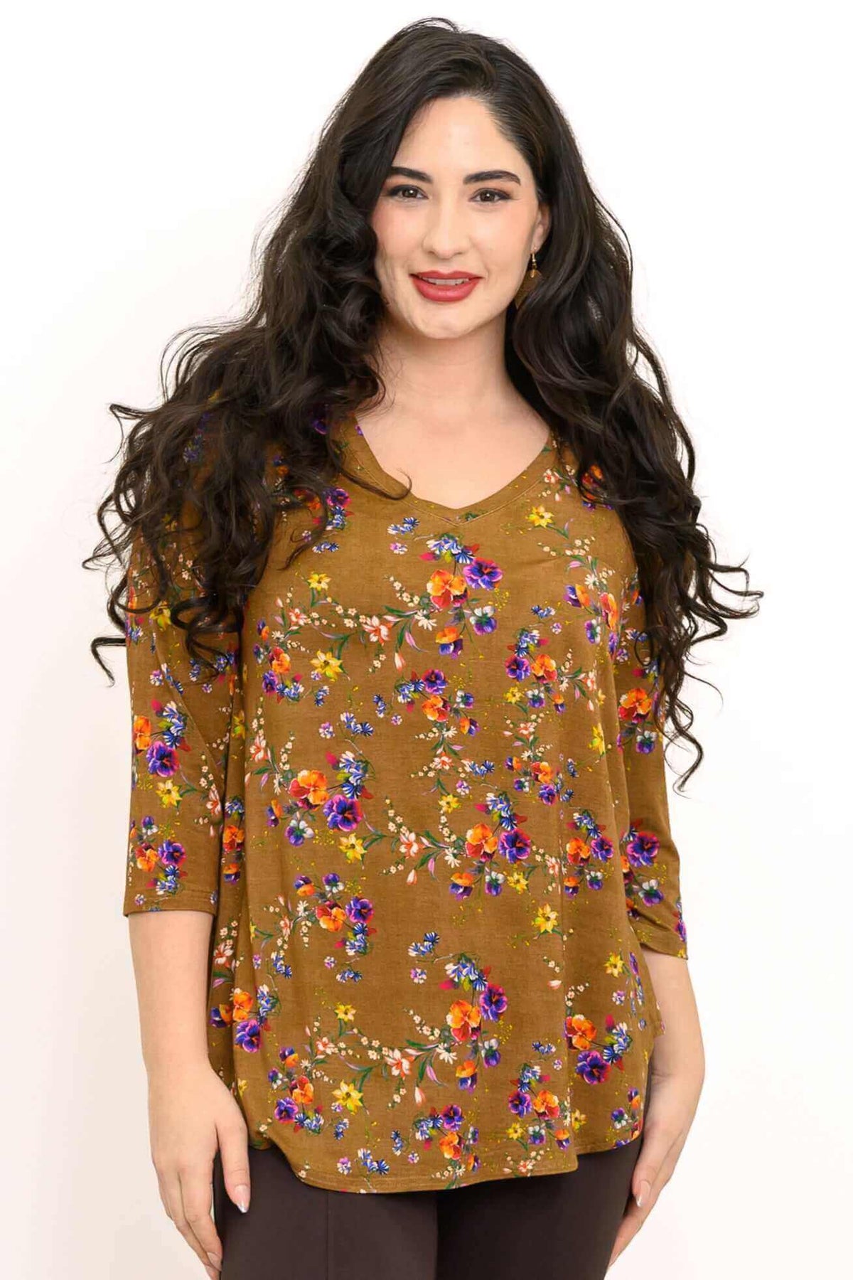 Woman wearing a marigold floral V-neck bamboo top with three-quarter sleeves