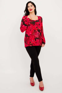 Model wearing Marissa Crimson Bloom tunic with black leggings and red shoes