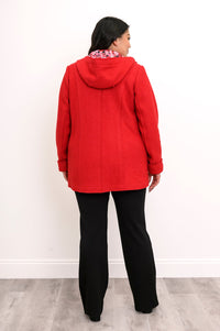 Back view of woman wearing bright red jacket showing red floral lining in the hood