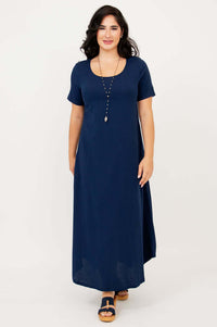 Woman facing forward wearing flowing navy maxi dress with short sleeves