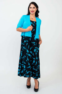 Woman wearing black and blue print dress with turquoise open cardigan
