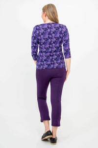 Rear view of woman in Mia Top violet pattern and purple pants showing back details
