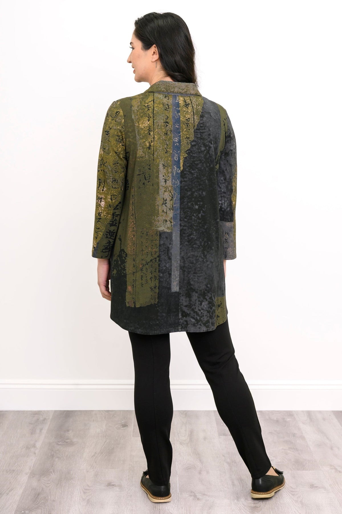 Back view of a patterned green knit top, showcasing a comfortable fit and hip-covering tunic length.