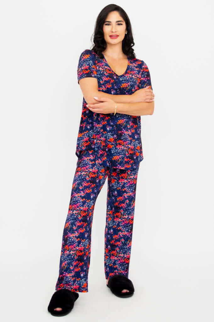 Model in floral bamboo lounge set with arms crossed and relaxed pose