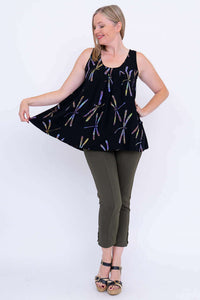 Woman showing flowy fit of black pleated dragonfly print tank top with outstretched arms