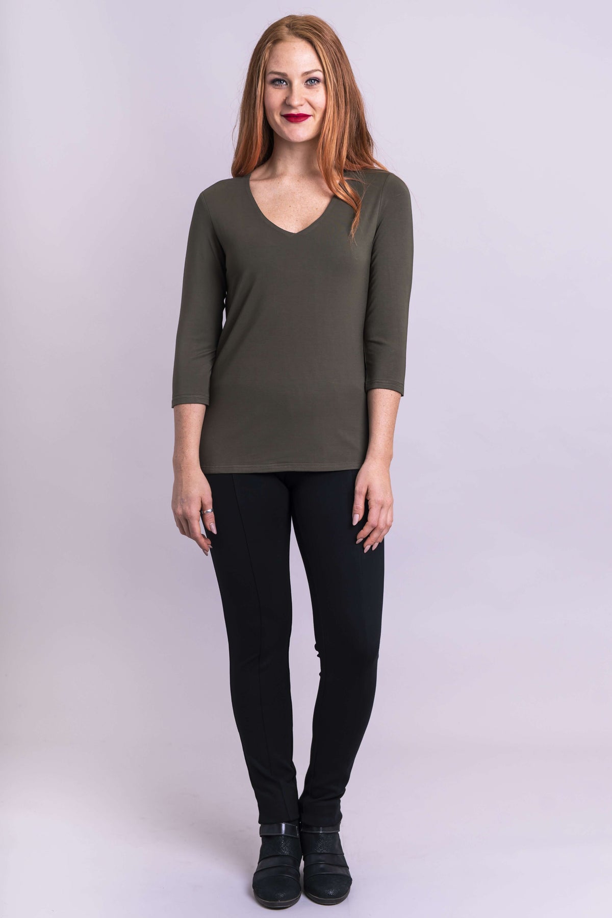 Model facing forward in olive bamboo top and black pants