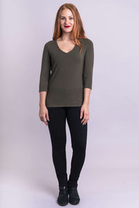Model facing forward in olive bamboo top and black pants