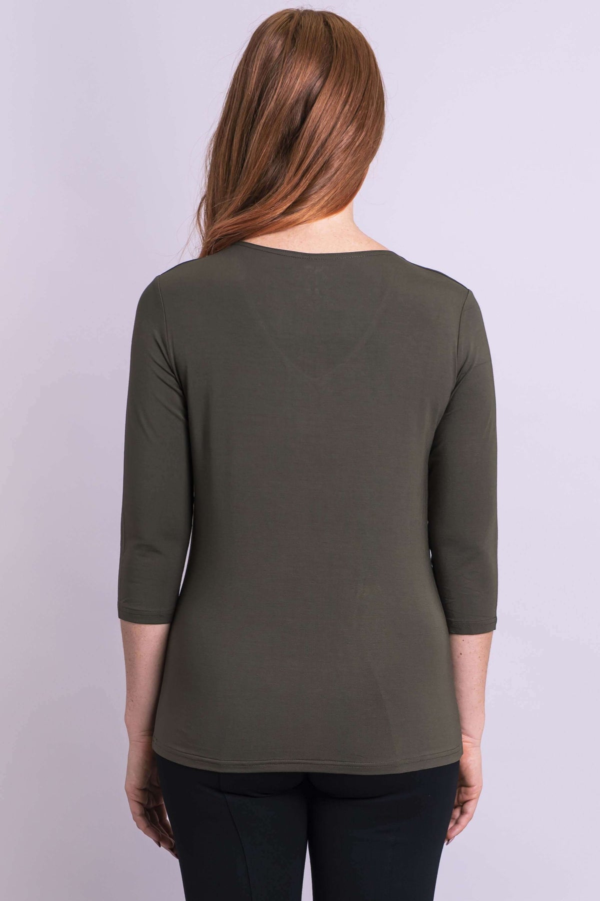 Model facing forward in olive bamboo top and black shoes