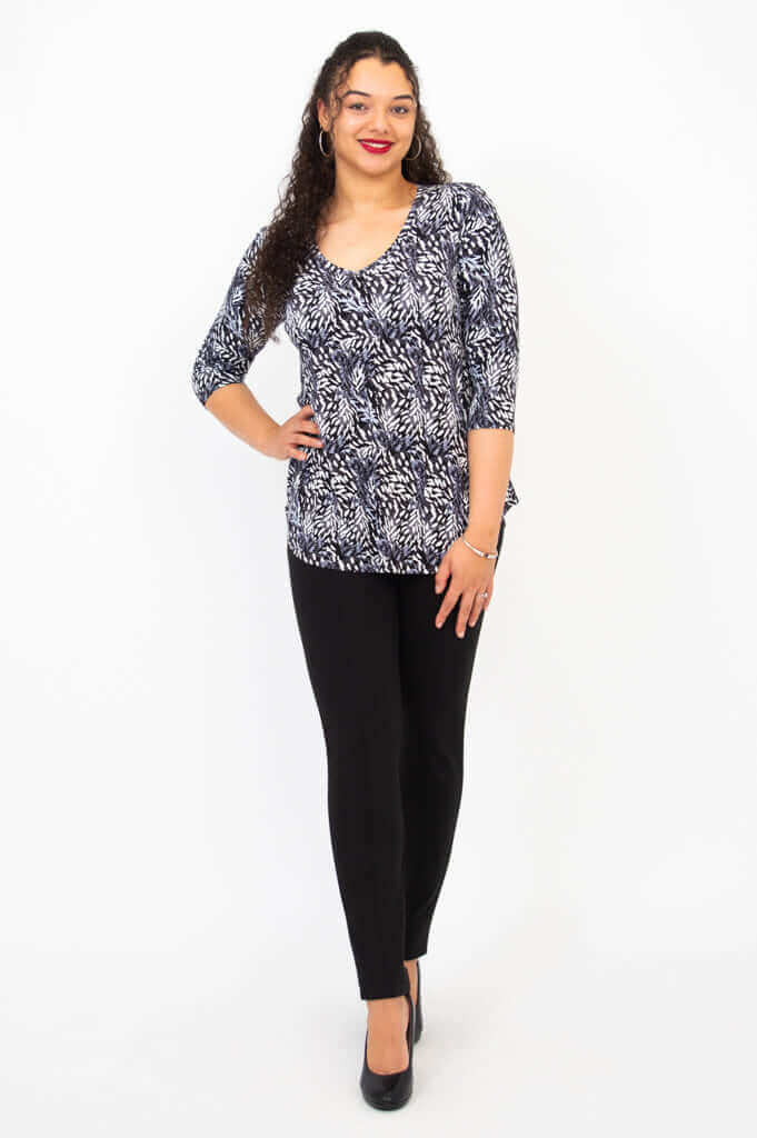 Model posing front view in Jackie V-Neck Bamboo Top Feather Black print