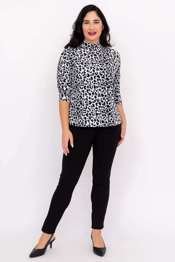 Model posing front view in animal print Highdrop Top and black pants