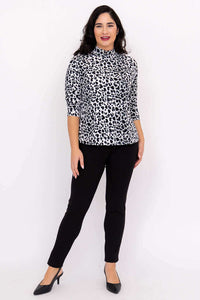 Model posing front view in animal print Highdrop Top and black pants