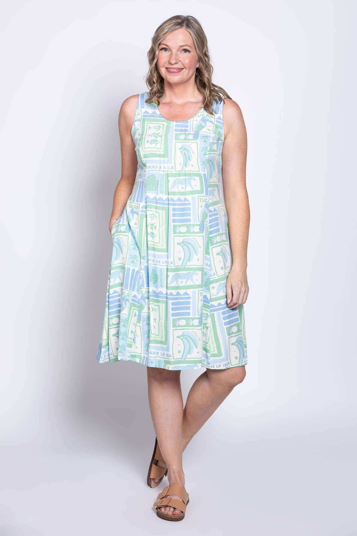 Model posing with hand in pocket in pastel print sleeveless Arden dress