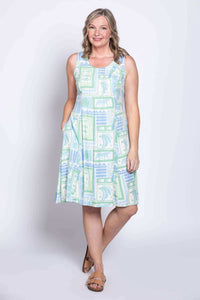 Model posing with hand in pocket in pastel print sleeveless Arden dress