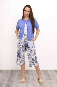 Model wearing blue floral capri Pant with purple short-sleeve cardigan