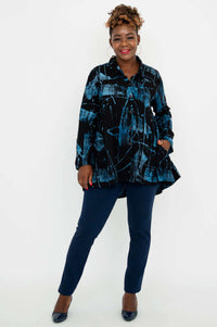 Woman modeling Peruva tunic top with hand in pocket, blue patterned shirt