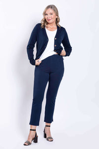 Model wearing navy slim-fit pants with a white top and navy cardigan, front view